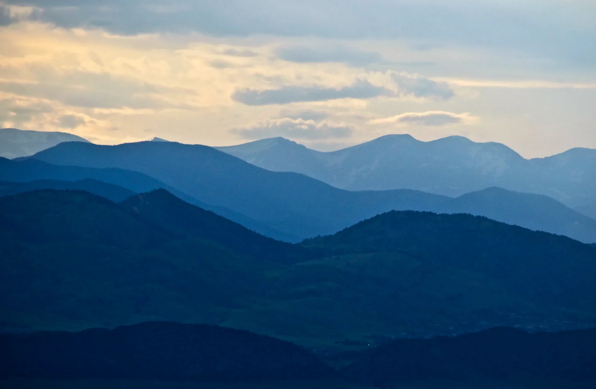 A view of the mountains from the top of a mountain.